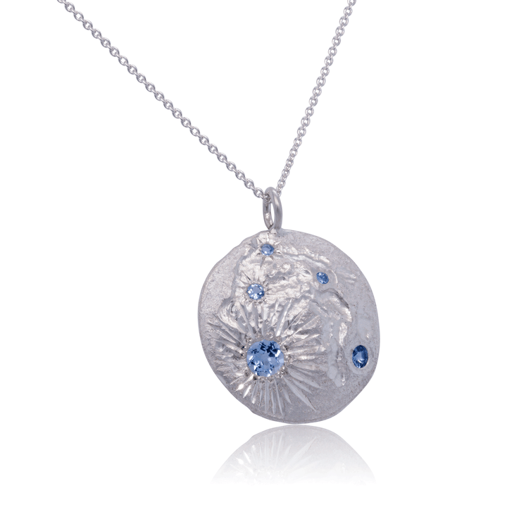 One-of-a-kind Luna pendant necklace in sterling silver with scattered blue gemstones, blending organic design with modern elegance.