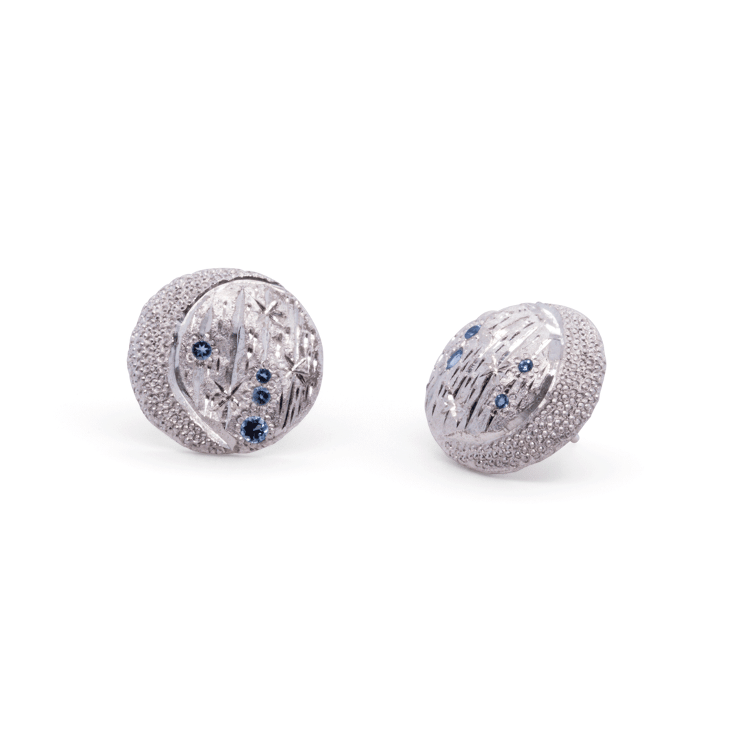 Janine Jewels handcrafted silver earrings featuring a starry night motif, blue topaz gemstones, and intricate artisanal detailing.