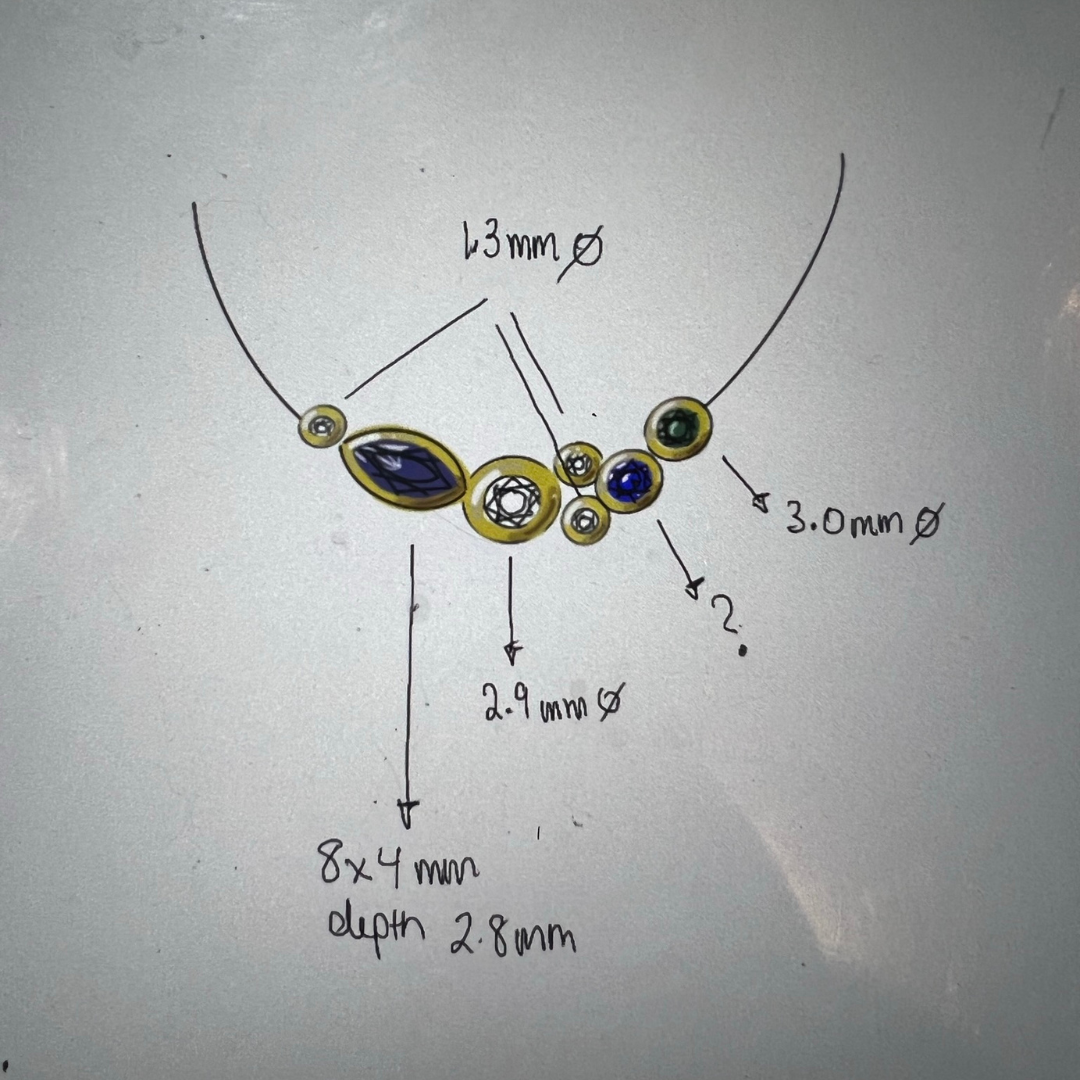 A technical drawing of a necklace design with precise measurements for the placement of marquise-cut and round gemstones, labelled with dimensions and specifications.