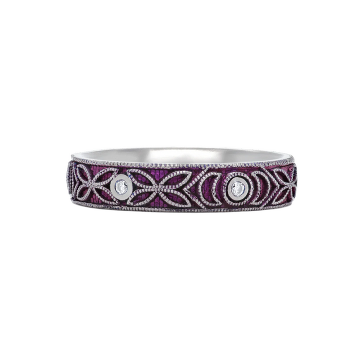 4mm titanium ring with purple anodized finish, featuring intricate floral engraving and six 1.3mm round white moissanite stones in bezel settings, designed for an active lifestyle and crafted with a blend of laser and hand engraving for a unique, vibrant look.