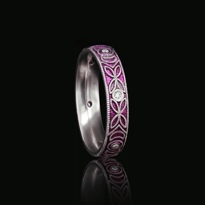 Three quarter view of Moonlit Meadow titanium ring in purple, showcasing detailed floral scroll engraving and moissanite accents, set against a black background.