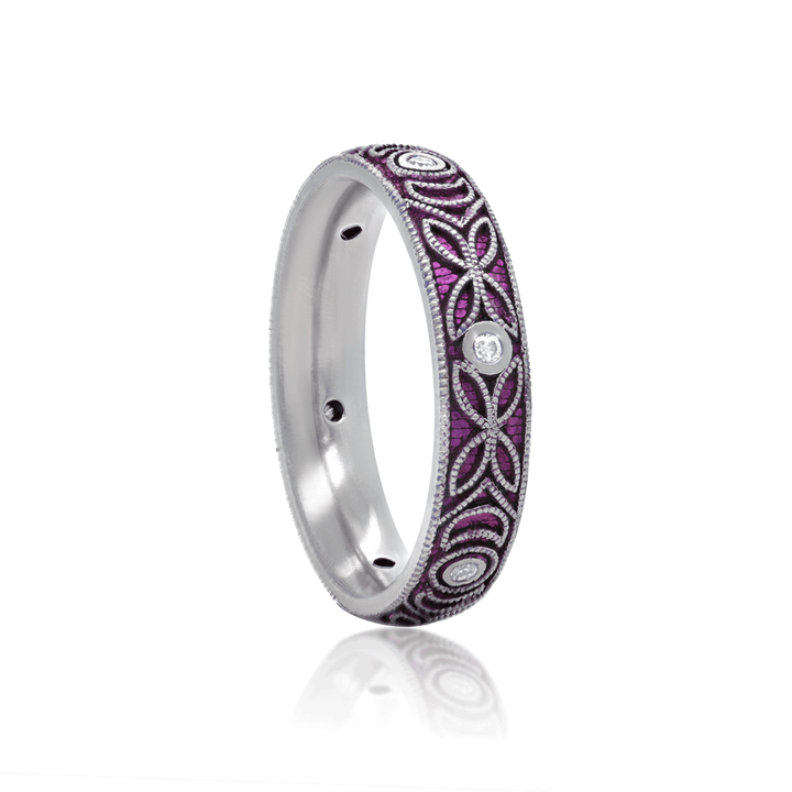 Three-quarter view of 4mm titanium ring with purple anodized finish, featuring intricate floral and moon engraving. Includes six 1.3mm round white moissanite stones in bezel settings, designed for an active lifestyle and crafted with a blend of laser and hand engraving for a unique, vibrant look. On white background.