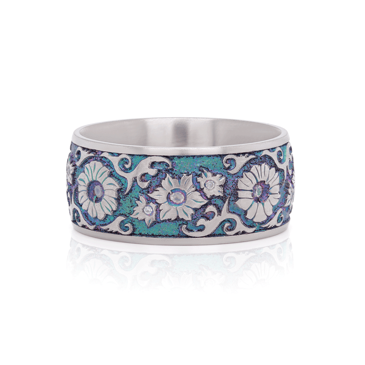 Front view of Floral Fantasy titanium ring, showing intricate hand-engraved floral patterns with moissanite accents, on a white background.